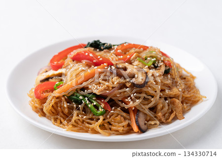Japchae, Korean stir fried glass noodles with vegetables, pork, soy sauce and sesame seed Japchae, Korean stir fried glass noodles with vegetables, pork, soy sauce and sesame seed 134330714