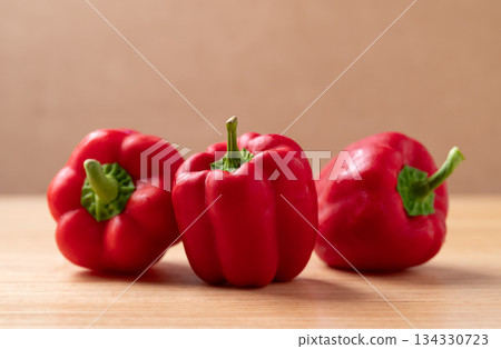 Fresh red bell pepper or sweet pepper on wooden background Fresh red bell pepper or sweet pepper on wooden background 134330723
