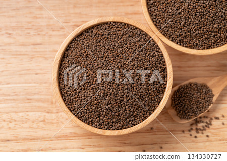 Dried perilla seed in a bowl with spoon on wooden background, Table top view 134330727