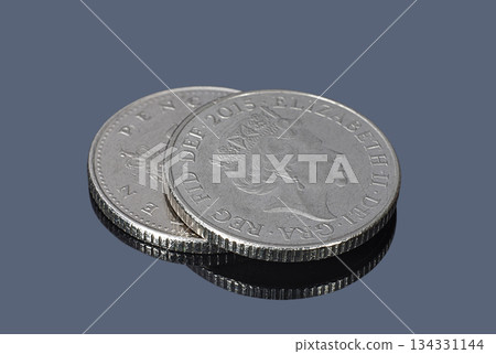 British ten pence coins on a dark background British ten pence coins on a dark background 134331144