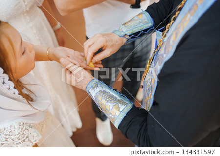 Ceremony of giving blessings to a child at a celebration 134331597