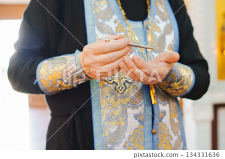 Priest conducting a service with a pen in hand Priest conducting a service with a pen in hand 134331636