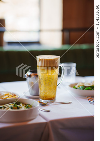 Enjoying a meal with beer in a cozy restaurant setting 134331660