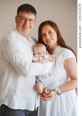 Loving family poses together with baby in peaceful setting 134331679