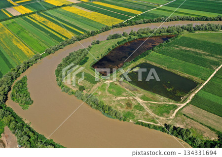 Aerial view of river gravel and sand ballast open pit mining abandoned lake Aerial view of river gravel and sand ballast open pit mining abandoned lake 134331694