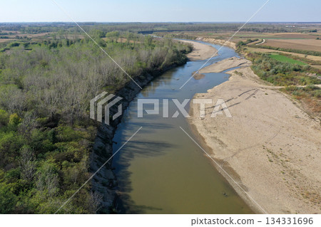 Flying over a river flowing on a plain aerial view Flying over a river flowing on a plain aerial view 134331696