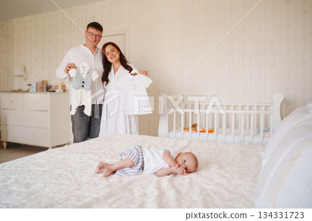 New parents prepare for their baby's arrival with outfits New parents prepare for their baby's arrival with outfits 134331723