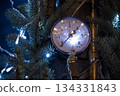 Close-up of a pressure gauge on a Christmas tree with festive fairy lights 134331843