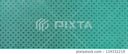 Dark green paper background with cyan metal foil pattern of teal stars for Christmas or New Year backdrop. 134332219