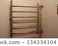 Chrome heating radiator on the wall in the bathroom 134334104