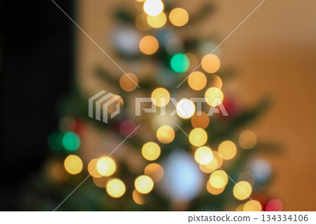 Colorful bokeh from a garland on a Christmas tree Colorful bokeh from a garland on a Christmas tree 134334106