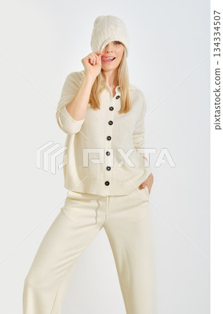 Model poses playfully in cozy winter outfit, showcasing casual fashion and comfort style Model poses playfully in cozy winter outfit, showcasing casual fashion and comfort style 134334507