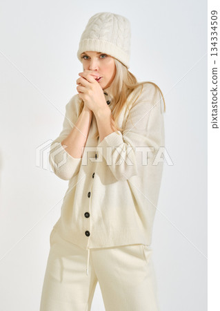 Winter fashion showcase featuring a woman in cozy attire indoors Winter fashion showcase featuring a woman in cozy attire indoors 134334509