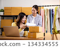 Two asian woman working on laptop and check document while managing and planning online business. 134334555
