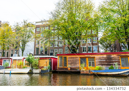 A floating house in Amsterdam canal water. 134334732