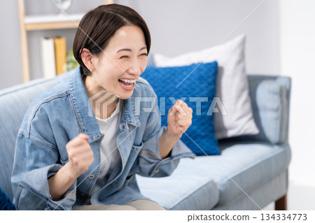 Women cheering watching sports Women cheering watching sports 134334773