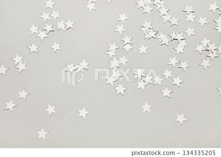 Cloud dancer colored star confetti sprinkling on solid gray background. Color of the Year Concept Cloud dancer colored star confetti sprinkling on solid gray background. Color of the Year Concept 134335205