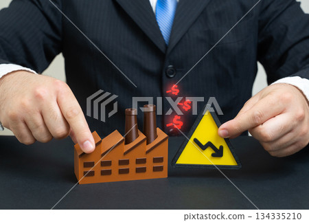 The industrial plant is suffering losses. Declining production, rising costs and market pressure. A concept for manufacturing crisis, industrial restructuring, economic downturn and business risk. The industrial plant is suffering losses. Declining production, rising costs and market pressure. A concept for manufacturing crisis, industrial restructuring, economic downturn and business risk. 134335210