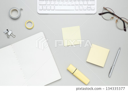 Organized workspace with stationery, keyboard, glasses and notebook creating productive atmosphere Organized workspace with stationery, keyboard, glasses and notebook creating productive atmosphere 134335377
