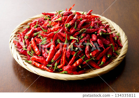 A pile of dried chili peppers in a colander A pile of dried chili peppers in a colander 134335811