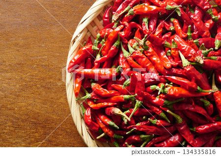 A pile of dried chili peppers in a colander A pile of dried chili peppers in a colander 134335816