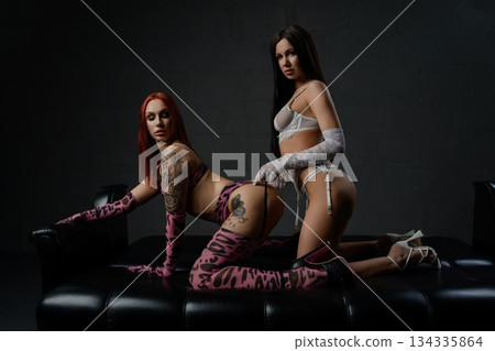 Sensual moment of a couple in lingerie showcasing confidence and allure 134335864