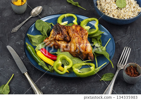 Grilled half chicken on a concrete kitchen table. Grilled half chicken on a concrete kitchen table. 134335983