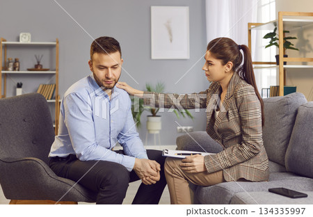 Female Psychologist Consulting Man During Therapy Session Visit 134335997