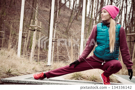 Sporty girl stretching outdoor in park. 134336142