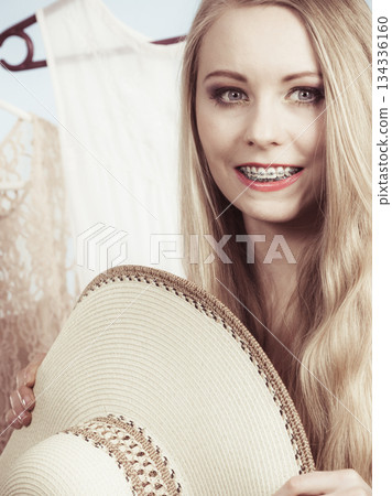 Woman in shop or wardrobe picking clothes Woman in shop or wardrobe picking clothes 134336160