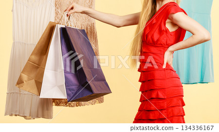 Woman in shop picking summer outfit Woman in shop picking summer outfit 134336167
