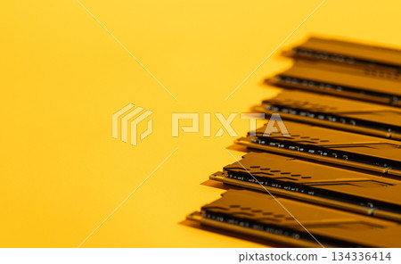 Diagonal row of black RAM modules on yellow background with copy space Diagonal row of black RAM modules on yellow background with copy space 134336414