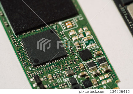 Macro of green M.2 SSD controller and electronic components Macro of green M.2 SSD controller and electronic components 134336415
