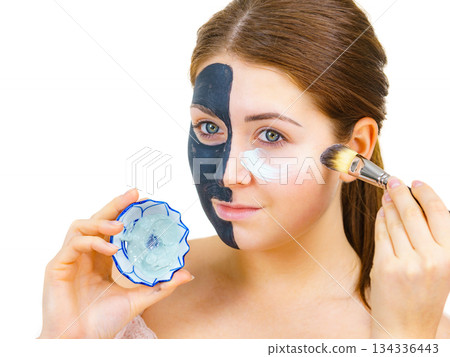 Girl black mask on half face apply white mud 134336443