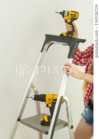 Woman with repairing tools and ladder 134336724