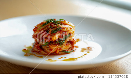 Fresh and Spicy Traditional Korean Kimchi Served on a Simple White Plate for Authentic Korean Cuisine 134337028