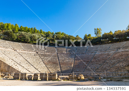 Ancient Theatre of Epidaurus is theatre in Greek city of Epidaurus, located on southeast end of sanctuary dedicated to the ancient Greek God of medicine, Asclepius in Peloponnese, Greece 134337591
