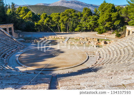 Ancient Theatre of Epidaurus is theatre in Greek city of Epidaurus, located on southeast end of sanctuary dedicated to the ancient Greek God of medicine, Asclepius in Peloponnese, Greece 134337593