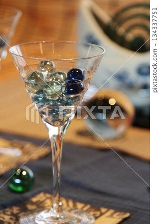 Glass and marbles 134337751