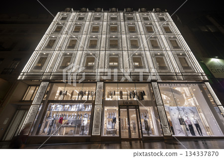 Paris, France - October 04 2025: Illuminated Paris Dior, Louis Vuiton boutique displays fashion Paris, France - October 04 2025: Illuminated Paris Dior, Louis Vuiton boutique displays fashion 134337870
