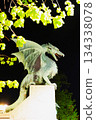A stone dragon statue standing on the railing of the Dragon Bridge in the center of Ljubljana, the capital of Slovenia 134338078