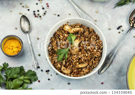 Bowl of buckwheat porridge on table. 134339040