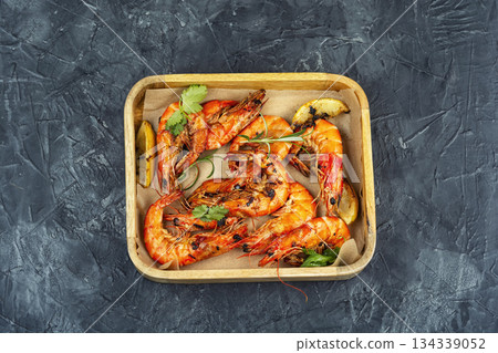 Grilled langoustines in wooden box, luxury food. Grilled langoustines in wooden box, luxury food. 134339052
