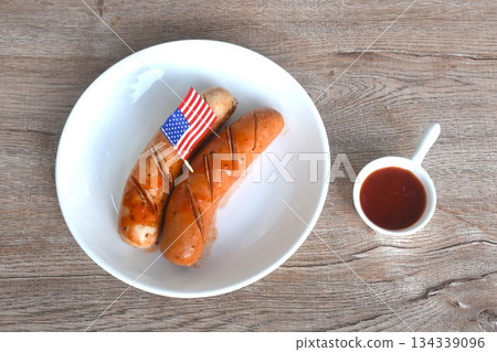 grilled smoked German and American pork sausage arranging on plate dipping ketchup sauce grilled smoked German and American pork sausage arranging on plate dipping ketchup sauce 134339096