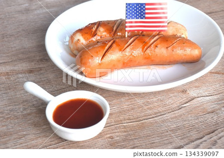 grilled smoked German and American pork sausage arranging on plate dipping ketchup sauce 134339097