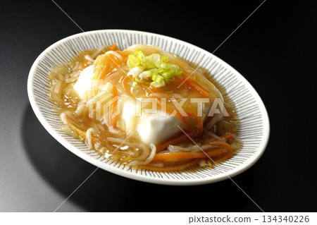 Silken tofu with thick bean paste photographed against a black background 134340226