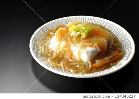 Silken tofu with thick bean paste photographed against a black background 134340227