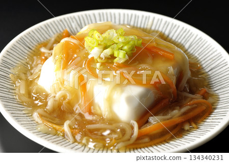 Silken tofu with thick bean paste photographed against a black background 134340231