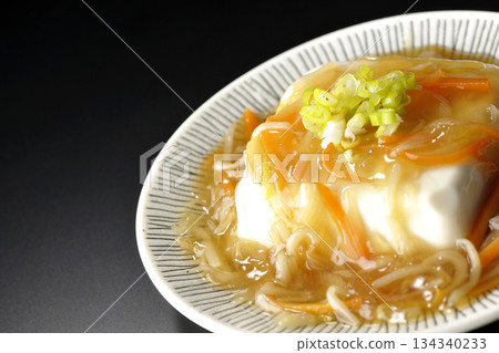 Silken tofu with thick bean paste photographed against a black background 134340233