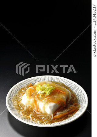 Silken tofu with thick bean paste photographed against a black background 134340237